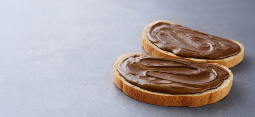 Toasts with chocolate butter on gray texture.