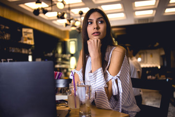 Young lady using laptop in coffee restaurant