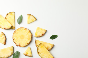 Flat lay with pineapple slices on white background, space for text