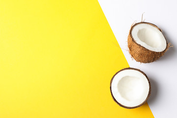Coconut halves on two tone background, space for text