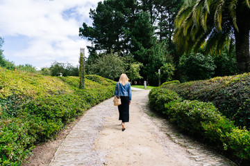 Fototapeta na wymiar woman on her back walks through a park