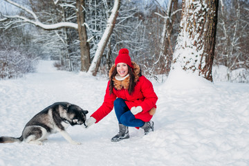 Fototapeta na wymiar Dog breed husky with girl outdoors. Dog for a walk with his owner