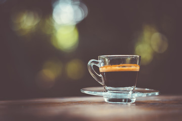 Espresso shot on wood table in cafe shop.