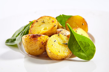 Baked potatoes with herbs dish closeup