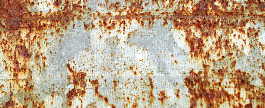 Rusted white painted metal wall. Rusty metal background with streaks of rust. 