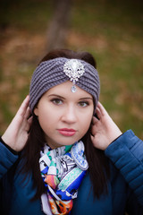 portrait of a young girl in a blue jacket and headband