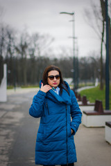 young girl in a blue jacket with glasses