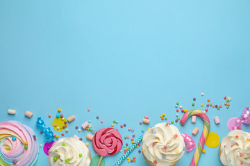 Flat lay composition with cupcakes on light blue background, space for text. Birthday party