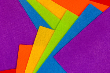 Abstract geometric pattern created with crafting felt in the LGBT rainbow flag colors of red, orange, yellow, green, blue and purple 