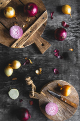 Red Onion Slices on wooden board with dark background