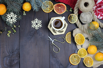 cup of coffee, Christmas tree toys, lemon, orange on a wooden table
