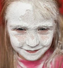 child's face in powdered sugar close up