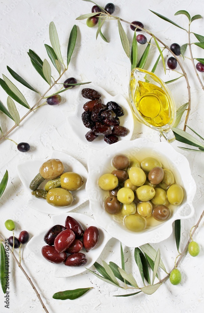 Poster olive products -  oil, dried olives, pickled, stuffed with cornichons. top view