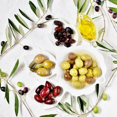 olive products -  oil, dried olives, pickled, stuffed with cornichons. top view