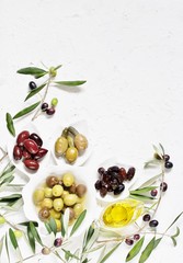olive products -  oil, dried olives, pickled, stuffed with cornichons. top view. copy space