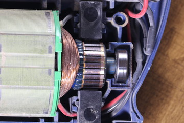 Electric motor with carbon brushes and commutator. Electric machine inside.