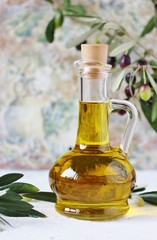 olive oil in a bottle and a sprig of fresh olives. copy space