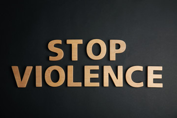 Fototapeta na wymiar Phrase STOP VIOLENCE on black background, flat lay
