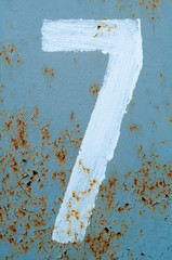 number 7 on painted rust wall