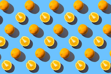 Round oranges on a blue background. Sunlight illuminates.