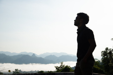 Fototapeta premium determined man, explorer pathfinder forest, military man forest, man with tactical gear at the cliff with mountain view, cool guy forest.