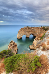 Fototapeta na wymiar Amazing seascape at sunset at Marinha Beach in the Algarve, Portugal. Landscape with strong colors of one of the main holiday destinations in europe. Summer tourist attraction.
