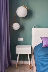  Scandinavian-style bedroom interior design with lilac curtains, white bedside table and ball lamps