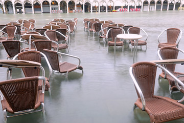 chairs on the water of Adriatic Sea in Main Square of Venice in