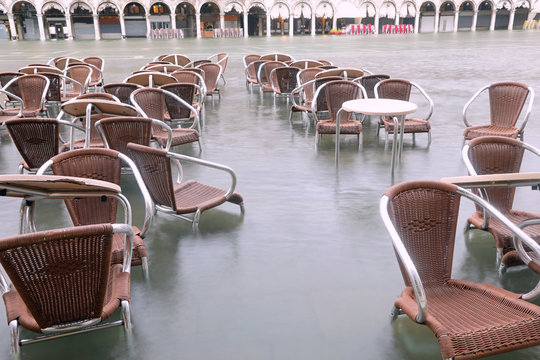 chairs on the water of Adriatic Sea in Main Square of Venice in
