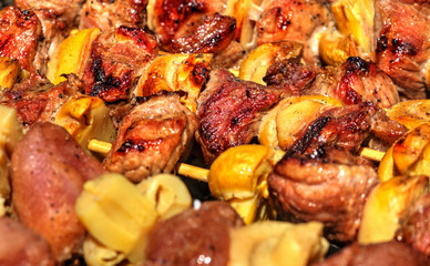 Grilling fresh meat and mushrooms on barbecue close up view