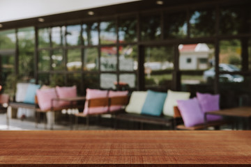 Empty wooden table blurred of restaurant cafe background and reception room, can be used for display or montage your products