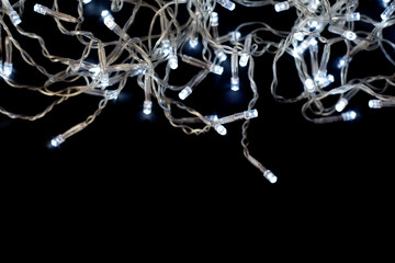 Fototapeta premium Christmas garland with lights on a black background.