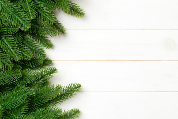 Top view of Christmas background made of fir tree branches. New year concept with copy space on wooden background