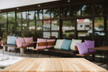 Empty wooden table blurred of restaurant cafe background and reception room, can be used for display or montage your products