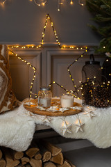 Composition of star made of garland, tray with food and christmas tree placed on bench. Holiday atmosphere