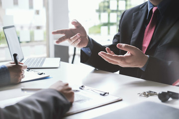 real estate agent holding house key to his client after signing contract,concept for real estate,...