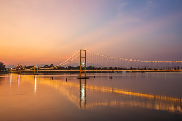 Fototapeta na wymiar Sunset view of the Golden Gate Bridge or 200 year Rattanakosin Sompoch bridge from Tak, Thailand.