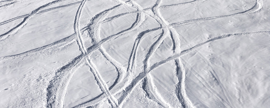 Off-piste ski slope with trace from skis