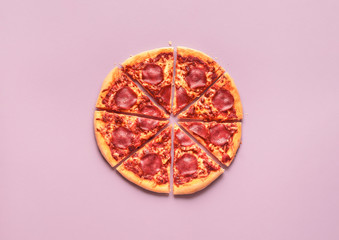 Whole pizza pepperoni cut in slices. Sliced Italian pizza salami
