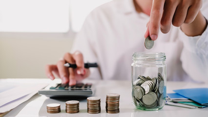 asian man working with calculator to calculate numbers. expenses calculator, payments costs with...