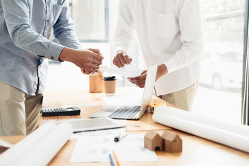 Architect or engineer working in office with blueprints,engineer inspection in workplace for architectural plan,sketching a construction project ,selective focus,Business construction concept.