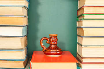 An inkwell, like a cup of transmitted knowledge, among books