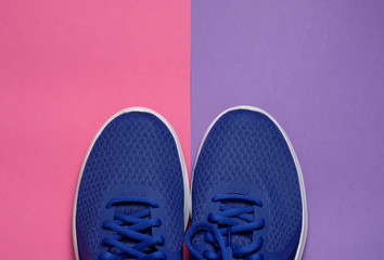 Sport sneakers on pink purple background with copy space for text. Sport objects background. Sports concept
