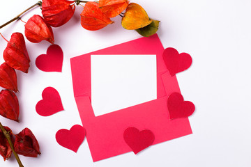 Red envelope on a white background with hearts. Valentines Day. Copy space, mockup