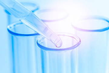 Science laboratory test blue tubes, macro flask equipment. Chemical dropper