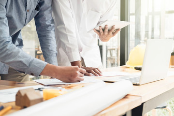 Architect or engineer working in office with blueprints,engineer inspection in workplace for architectural plan,sketching a construction project ,selective focus,Business construction concept.