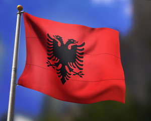 Albanian flag waving in blue sky