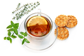 Tea with herb leaf mint thyme and cookies. Still life of black with lemon. Isolated on white background.