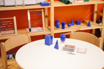 school envoirement, games and geometric forms to learn in Montessori math class.