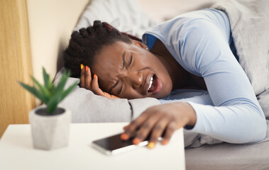 African American Girl Suffering From Migraine Lying In Bed Indoor